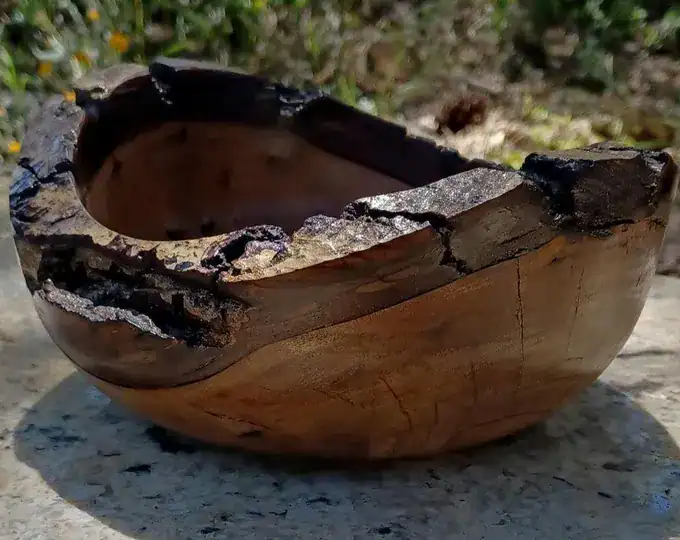 Close-up of a hand-turned wood piece with rich grain.